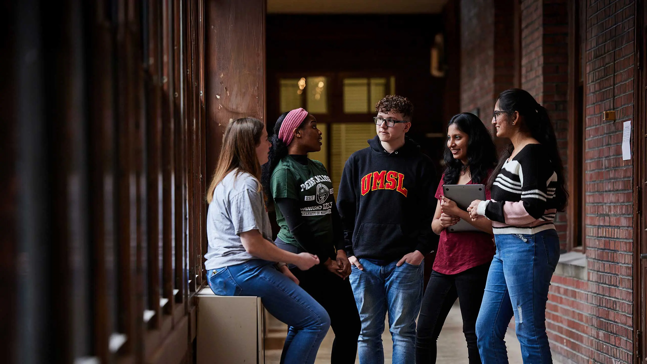 Students having conversation in hallway