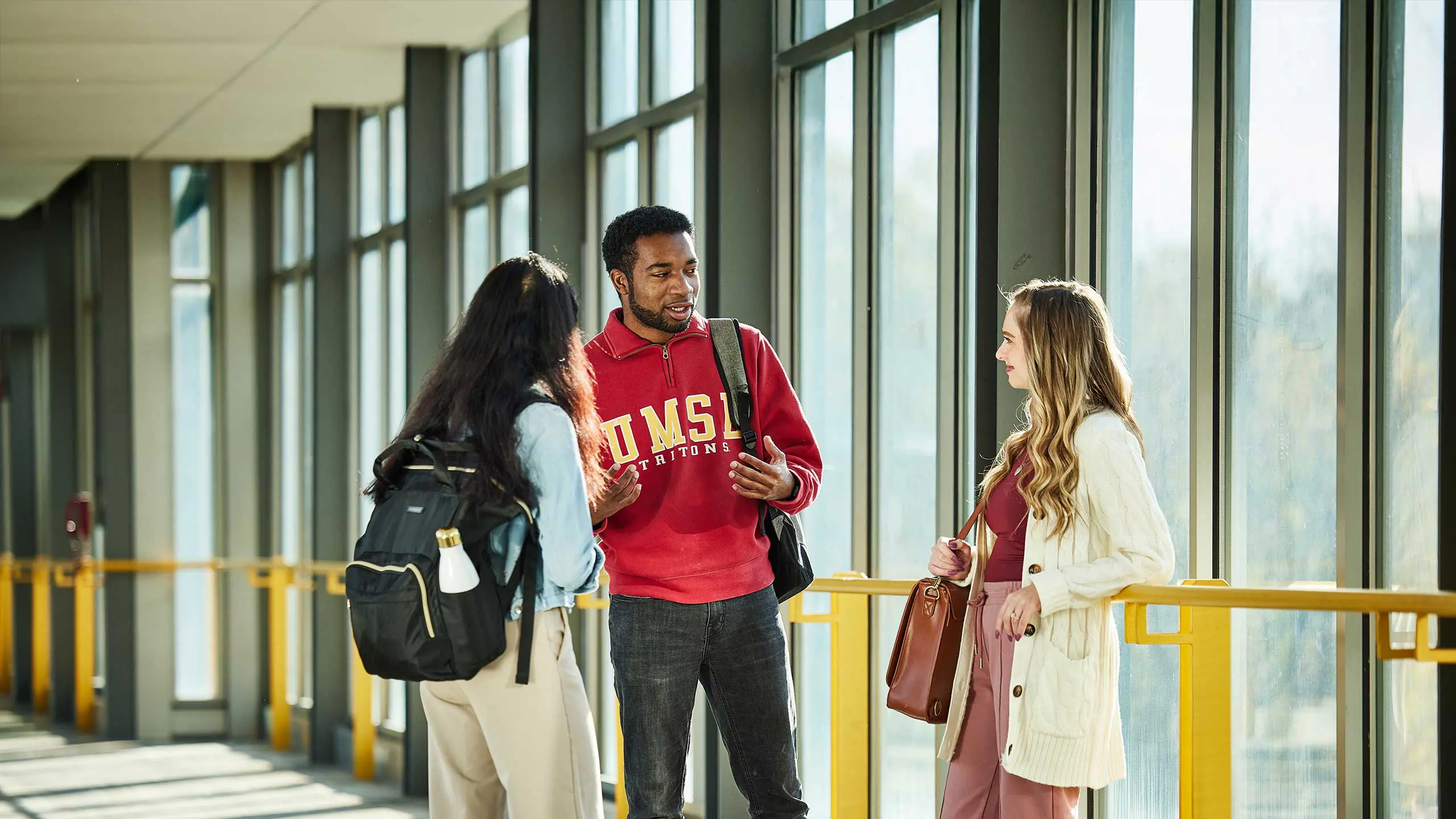 Students having a conversation in hallway